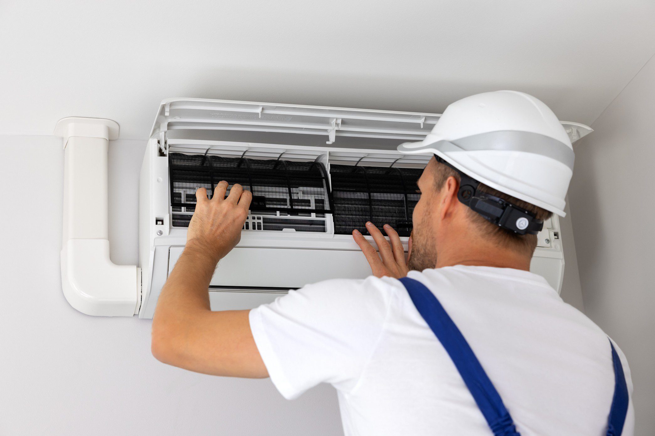 Worker fixing air conditioning system