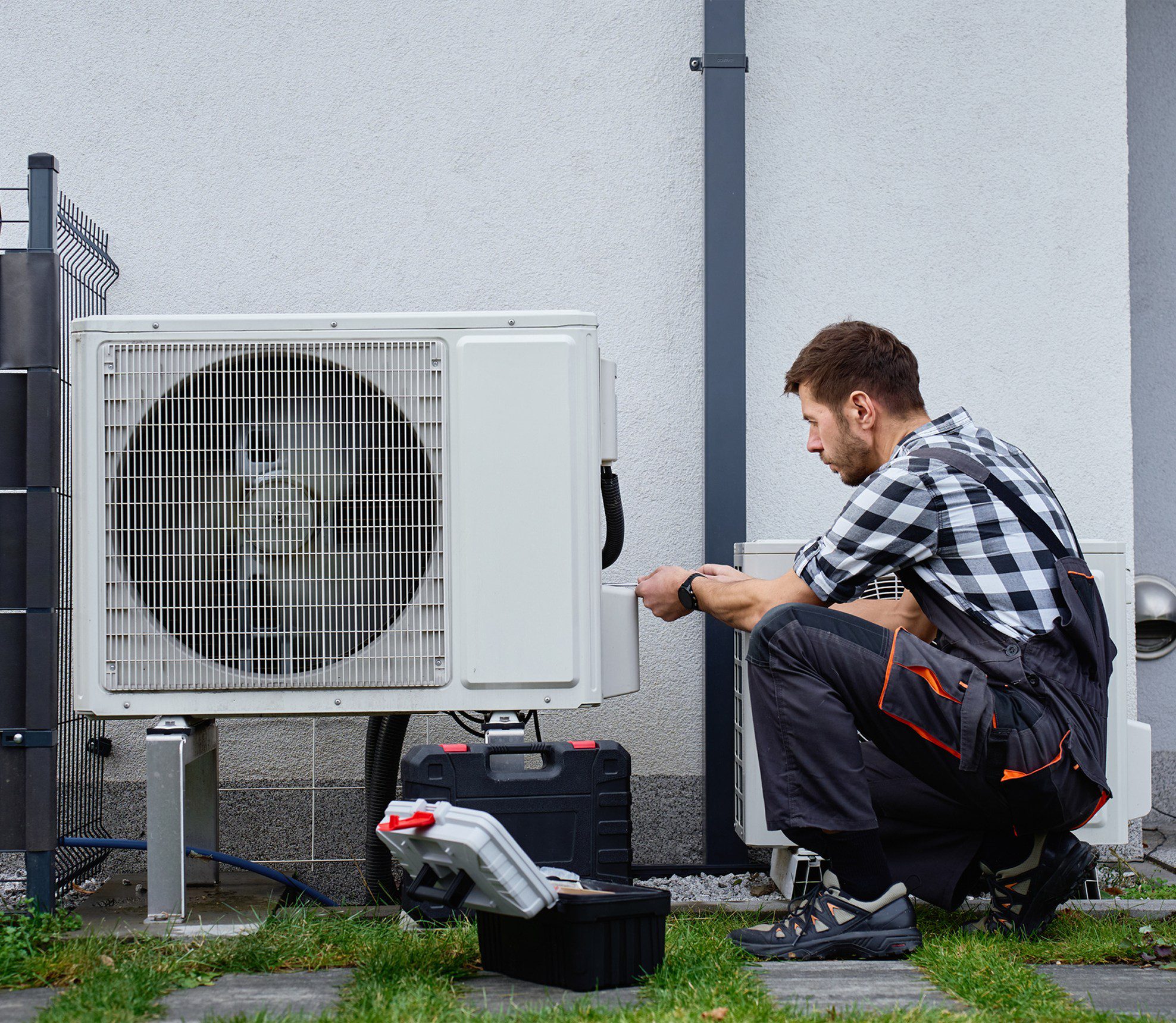 Man servicing exterior AC system