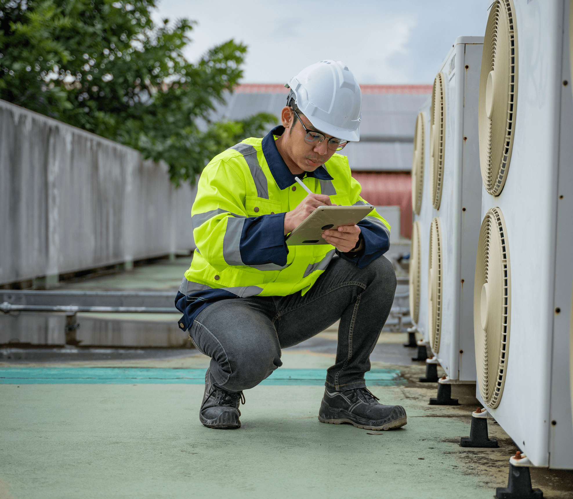 Worker with tablet near ventilation units