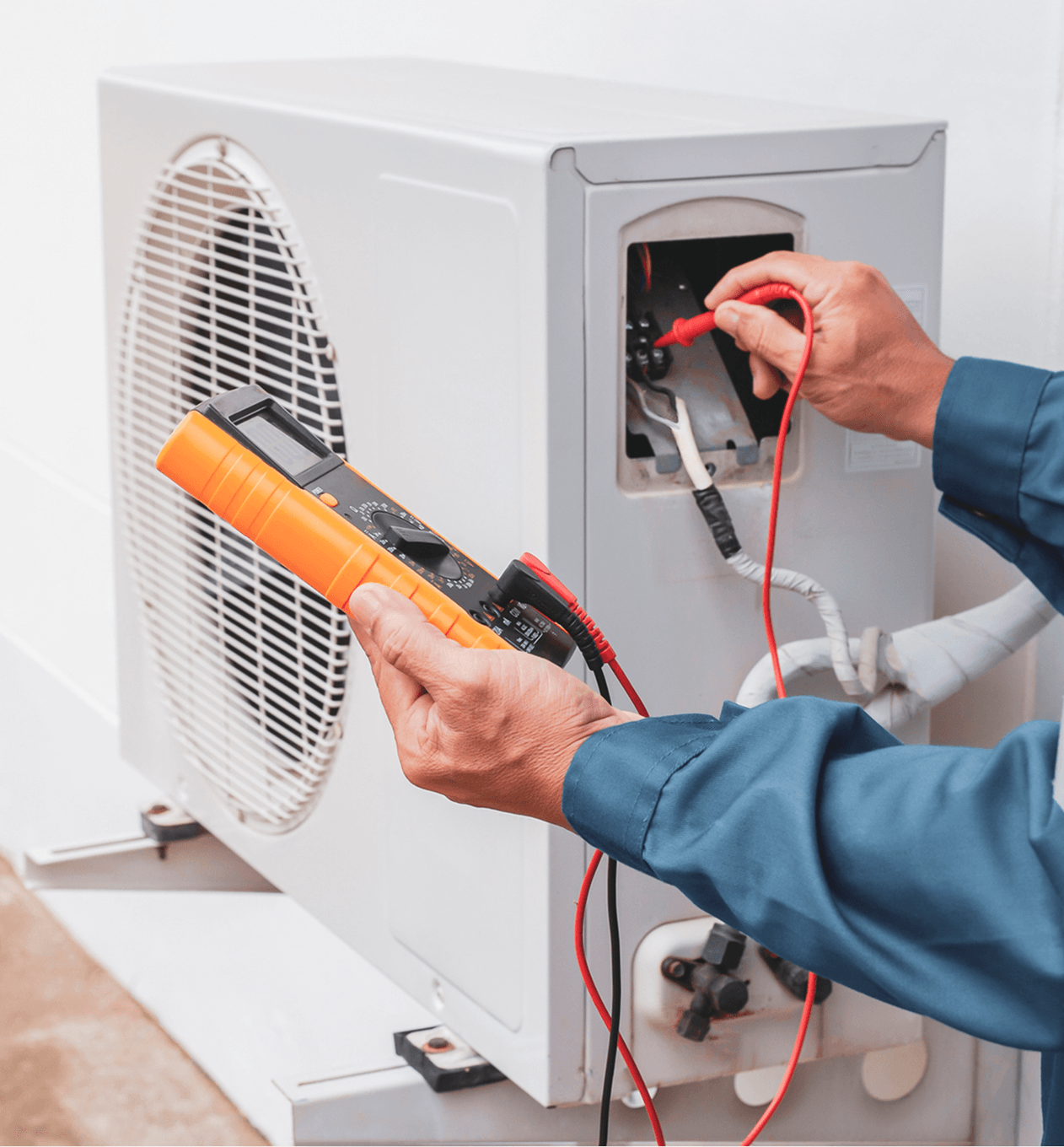 Technician testing air conditioning unit