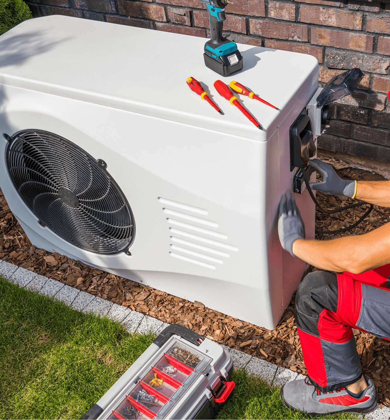 Technician repairing outdoor HVAC unit