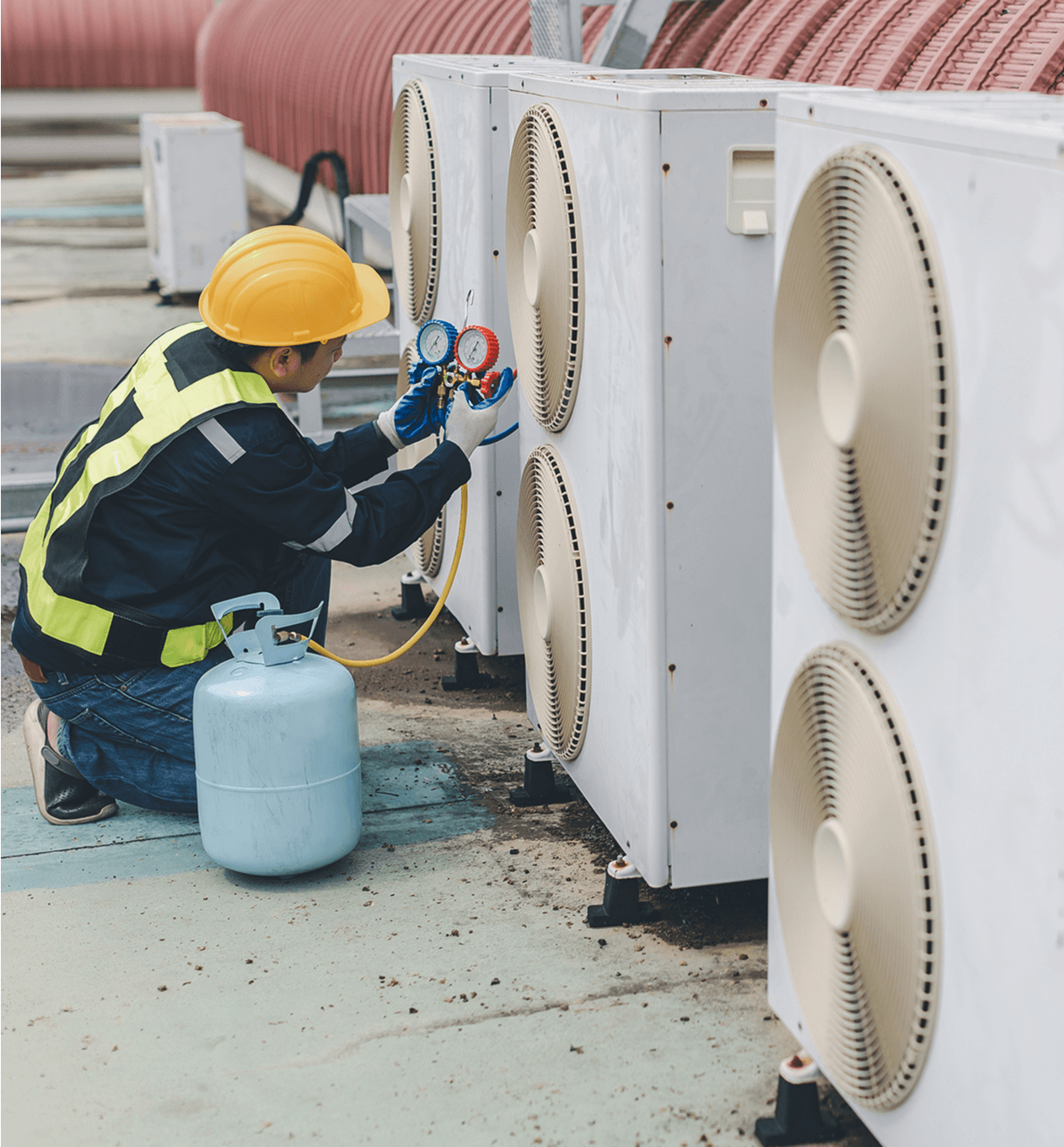 Worker performing air conditioner maintenance task