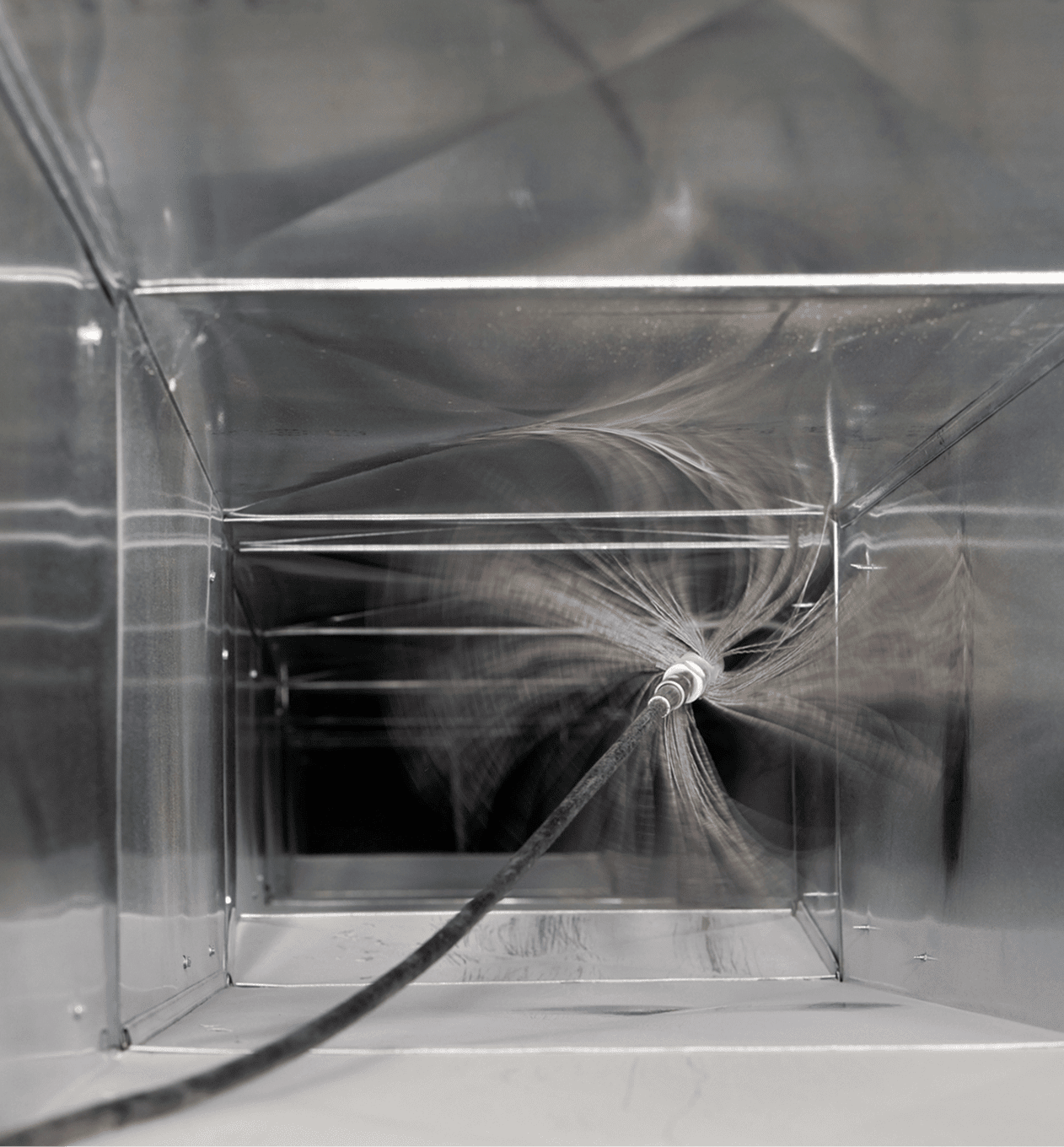 Air duct cleaning brush inside metal ductwork