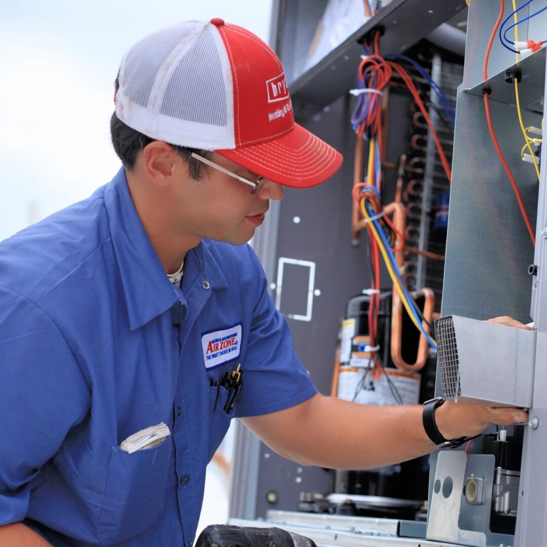 Chris repairing an outdoor HVAC unit